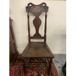 An early 18th Century Welsh oak chair or back stool, with shaped splat and crest rail, 44" h.