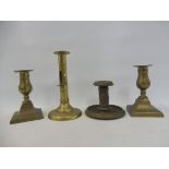 Four Victorian brass candlesticks.