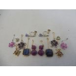 A collection of earrings, including a 9ct pair set with sapphires, some with certificates.