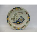 An 18th Century Delft charger, of well detailed and colourful design, 13 1/4" diameter.