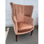 A 19th Century upholstered barrel-backed armchair raised upon square tapering front supports to