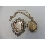 A silver oval locket with floral engraved front, Birmingham 1975, plus an unusual silver marcasite