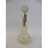 A cut glass slender scent bottle with a deep silver collar and cut glass stopper, marks rubbed.
