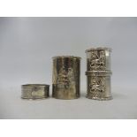 Two Ethiopian silver napkin rings, a matching cylindrical pot and a sterling silver napkin ring.