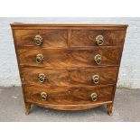 A 19th Century mahogany bow fronted chest of two short over three long drawers with brass ring