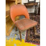 A 1960s chair, with orange vinyl upholstery.