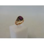 A yellow metal ring, probably high quality gold, set with a heavily scratched amethyst, unmarked,