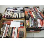 A large collection in four boxes of Manchester United books and DVDs, 26 signed books including