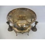 An oval silver plated food warmer, a silver plated oval tray and a pair of candlesticks.