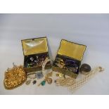 Two tins of assorted costume jewellery, an evening bag etc.