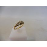 An 18ct gold five stone diamond ring, size L/M, 2.7g.