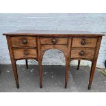 A George III mahogany and boxwood strung serpentine fronted sideboard, with paterae inlay, raised