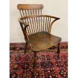 An early 19th Century yew wood low comb back Windsor armchair, 32 1/4" h.