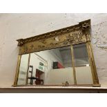 A Regency giltwood overmantle mirror with a deep frieze to the top, of lions pulling a chariot, 55