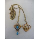 An Art Nouveau design 9ct gold pendant set with two oval turquoise stones and seed pearls, on a