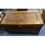 A Camphorwood Chest, the heavily carved exterior in foliate and bird deocration, hinged lid