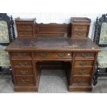 An Edwardian walnut twin Pedestal Desk, by Maple & Co. Ltd., with raised back and tooled leather