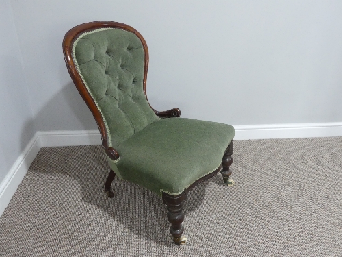 A Victorian walnut button back Nursing Chair, with spoon shaped back, turned front supports on