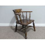 A late 19thC ash and elm smokers bow Armchair, with spindle gallery and sweeping arms, shaped saddle