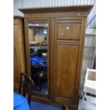 An Edwardian mahogany double Wardrobe, the one glazed door opening to hanging space, the other