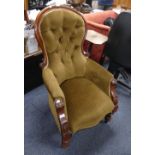 A Victorian walnut framed button back Armchair, with turned supports and brass castors, pale green