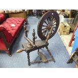 A vintage oak Spinning Wheel, 34in (86.5cm) long, 22in (56cm) wide, 39in (99cm) high.