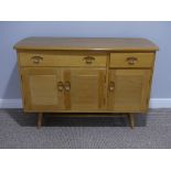 A mid 20thC Ercol light elm and beech Sideboard, Model 351, with a long drawer above a double