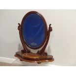 A Victorian mahogany Dressing Table Mirror, the oval swing mirror with a velvet lined