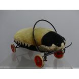 Steiff; A vintage (c.1950's) child's ride-on Ladybird, the mohair top faded, wheels marked 'Steiff