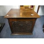 An antique oak Coal Box, with hinged top and carved panels, together with an Arts & Crafts style