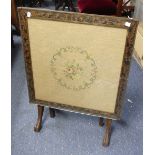 An Edwardian mahogany Fire Screen/Tilt-top Table, an embroidered inset with floral decoration