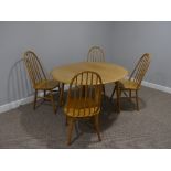 A mid 20thC Ercol style drop leaf oval Dining Table, the top 44in (112cm) x 49in (124.5cm) extended,