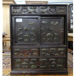 An early 20thC Japanese oak Table Top Cabinet, with a pair of sliding doors and five various