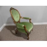 A Victorian walnut showframe open Armchair, with gilt carved decoration, the leaf leaf capped
