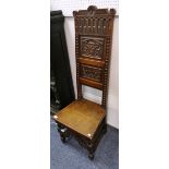 A Victorian carved oak Hall Chair, the high back carved with a family crest and motto "Dieu Est",