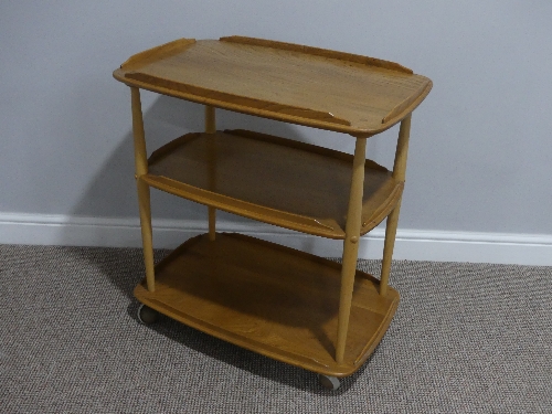 A mid 20thC Ercol three tier Trolley, Windsor 458, the rounded rectangular lipped elm shelves on