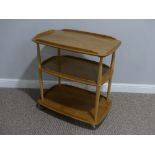A mid 20thC Ercol three tier Trolley, Windsor 458, the rounded rectangular lipped elm shelves on