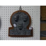 An antique style lead Firemark, in the form of three leopards heads in relief, numbered 5266, and