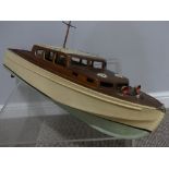 A Vintage 1950's electric Pond motor Boat, painted wood and mahogany, 28in (71cm) long.