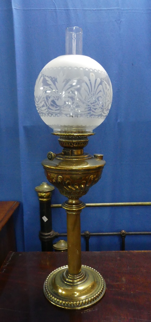 A Victorian style brass Oil Lamp, the brass reservoir with swirl fluted decoration, with funnel