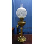 A Victorian style brass Oil Lamp, the brass reservoir with swirl fluted decoration, with funnel