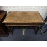 An early 20thC Continental oak Side / Console Table, with foliate carved frieze and single drawer,