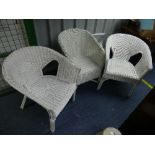 A pair of white paintd Lloyd Loom style armchairs, one with damage to canework on one leg, 22in (