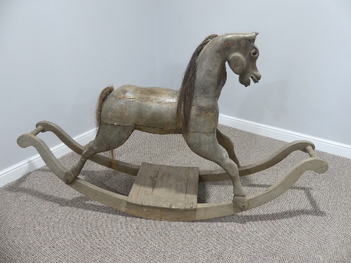 A vintage carved wooden Rocking Horse on bow rockers, with real horse hair mane and tail ,forelock