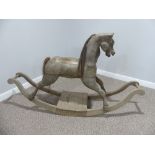 A vintage carved wooden Rocking Horse on bow rockers, with real horse hair mane and tail ,forelock