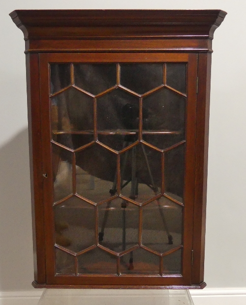 A George III astragal glazed wall-hanging Corner Cupboard, 27in (69cm) wide, 15in (38cm) deep,