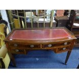 An Edwardian inlaid mahogany lady's knee hole Writing Desk, bow front with gilt red leather inset