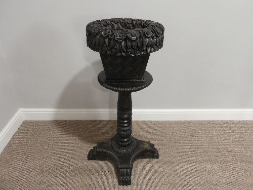 A 19thC Anglo-Indian carved ebony Plant Stand, formed of a lift-off basket shaped planter with woven