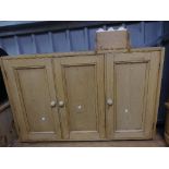 A vintage pine Cupboard, comprising one sliding door flanked by two hinged doors, enclosing