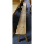 A large 20thC pine Bench, 97in (246cm) long x 9in (23cm) deep x 20½in (52cm) high